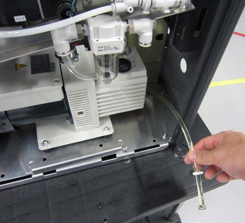 ULVAC HELIOT 900 backing pump and oil mist trap inside instrument cabinet — maintenance access view